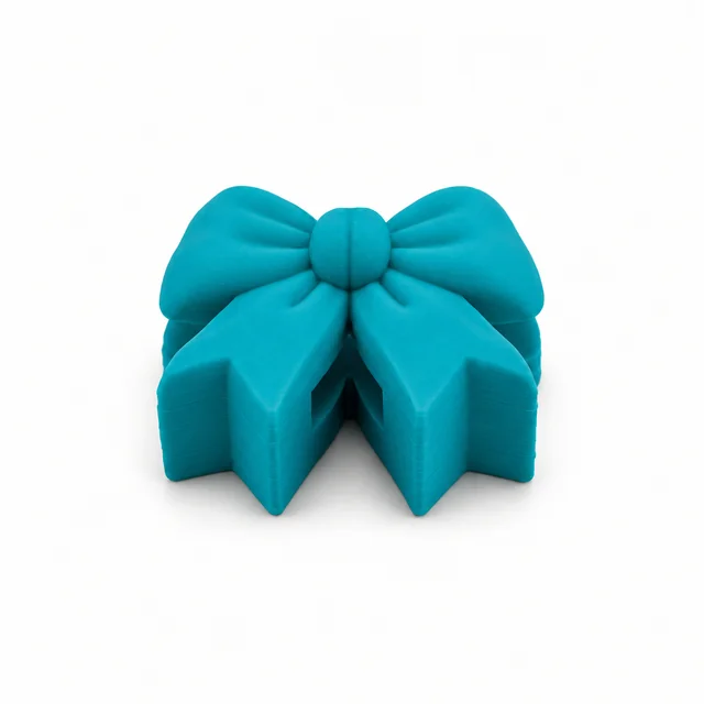 Front view of an aquamarine bow with folded loops and ribbon tails.