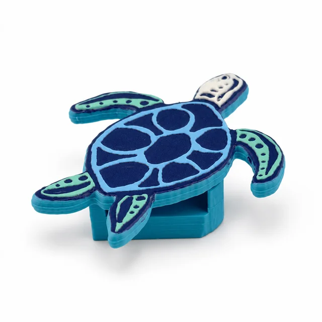 A turquoise sea turtle with a dark blue patterned shell.